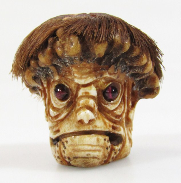 Appraisal: A thC Japanese netsuke formed as a face with realistic