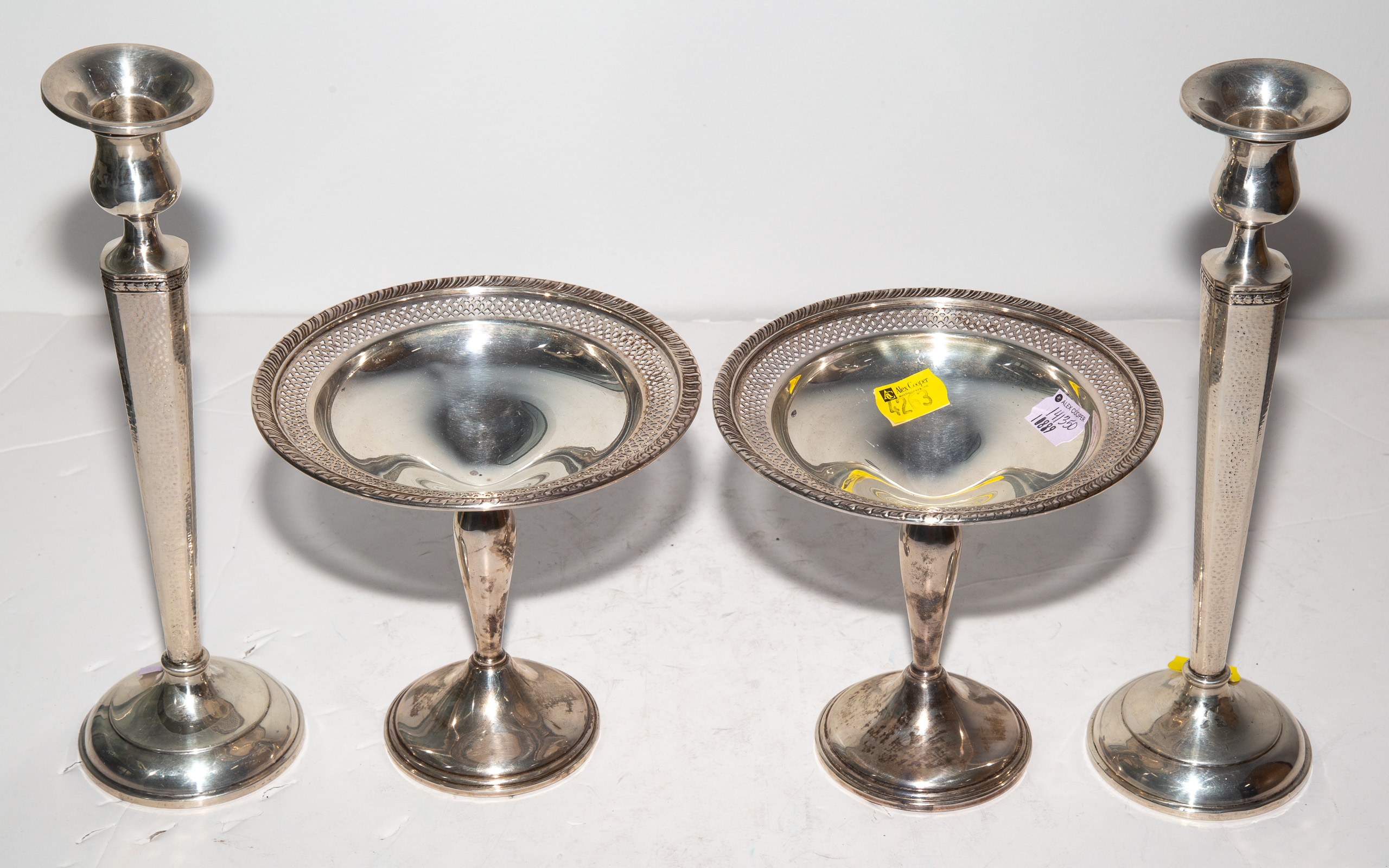 Appraisal: A PAIR OF WEIGHTED STERLING CANDLESTICKS COMPOTES in to in