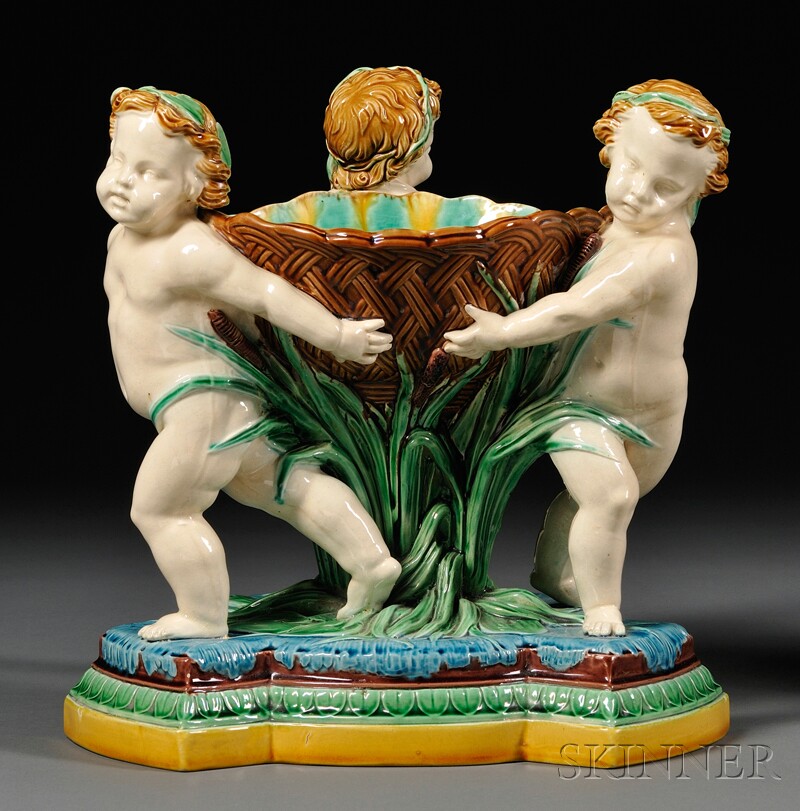 Appraisal: Minton Majolica Figural Centerbowl England c the three putti carrying