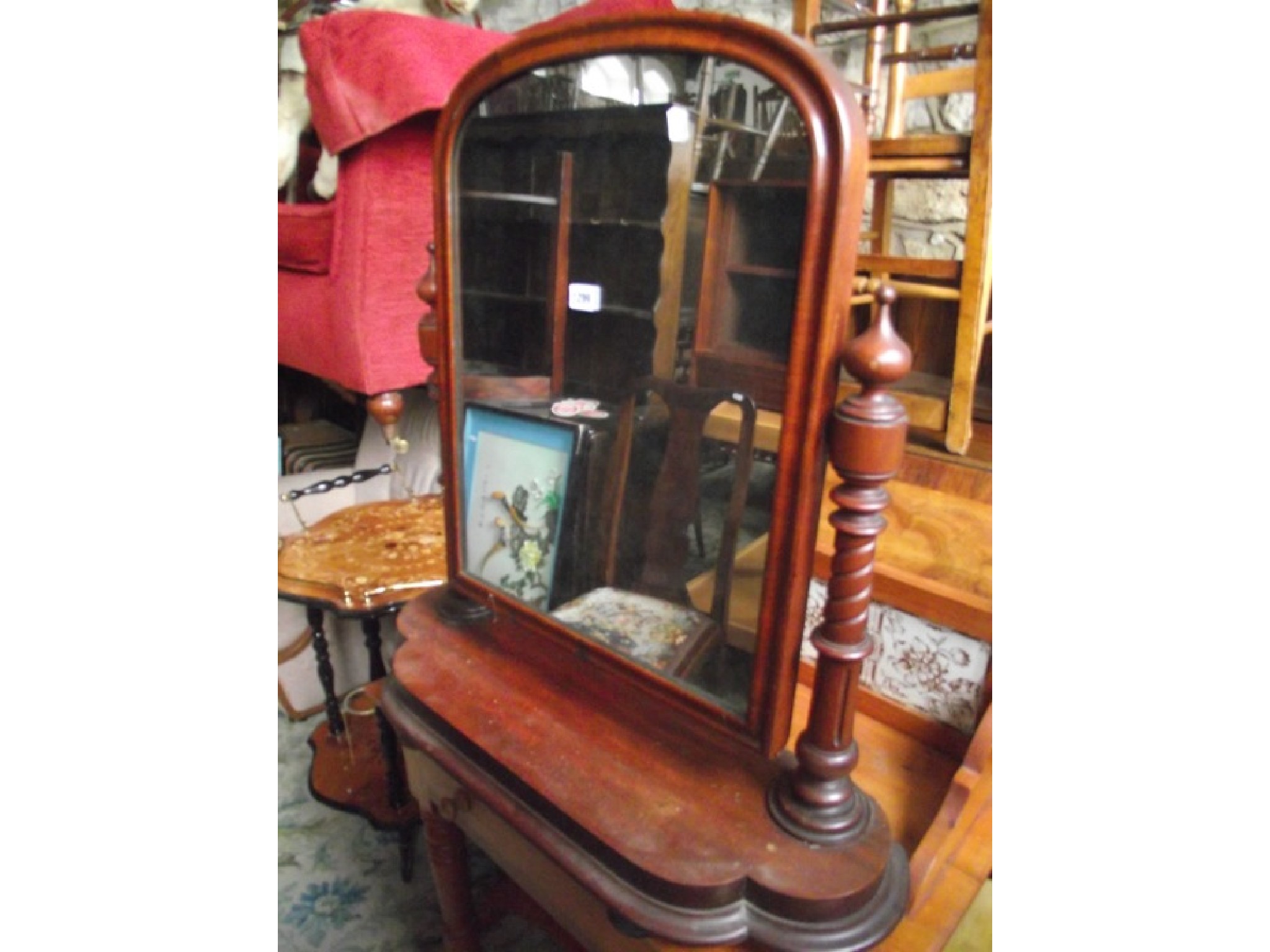 Appraisal: A Victorian mahogany toilet mirror with arched moulded frame raised