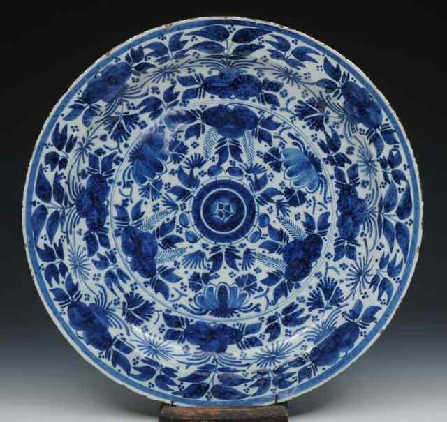 Appraisal: A LARGE DELFT CHARGER with simple blue foliate designs th