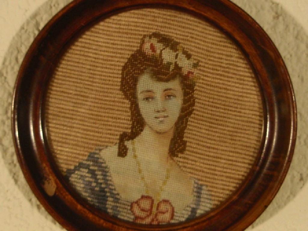 Appraisal: A small circular embroidered picture Head and shoulders study of