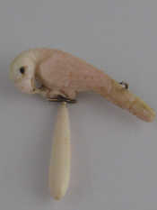 Appraisal: A carved coral brooch designed as a bird with yellow