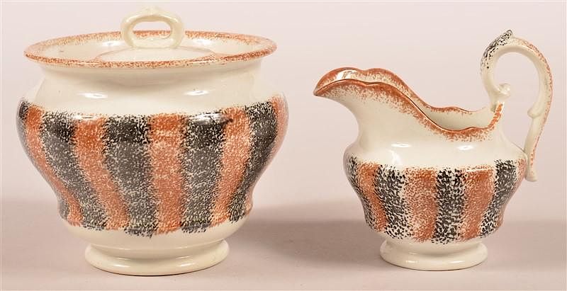 Appraisal: Rainbow Spatter Sugar Bowl and Cream Pitcher Black and Brown