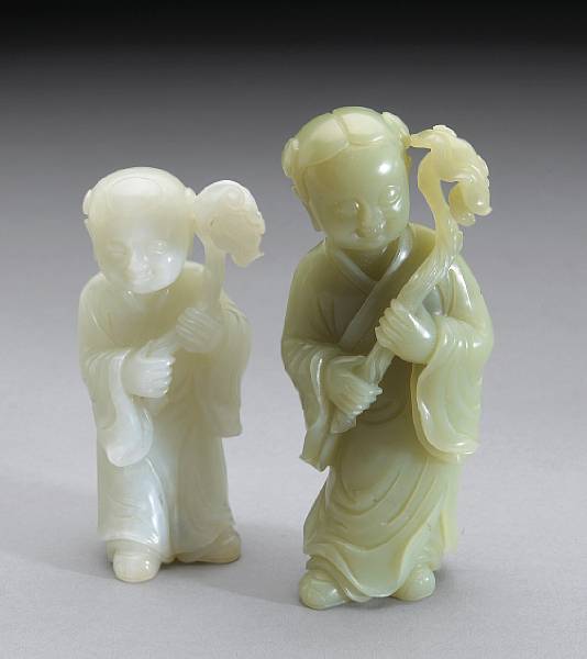 Appraisal: Two jade carvings of children Each shown holding a lingzhi