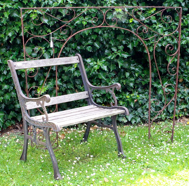 Appraisal: A GARDEN SEAT with cast iron ends and slatted back