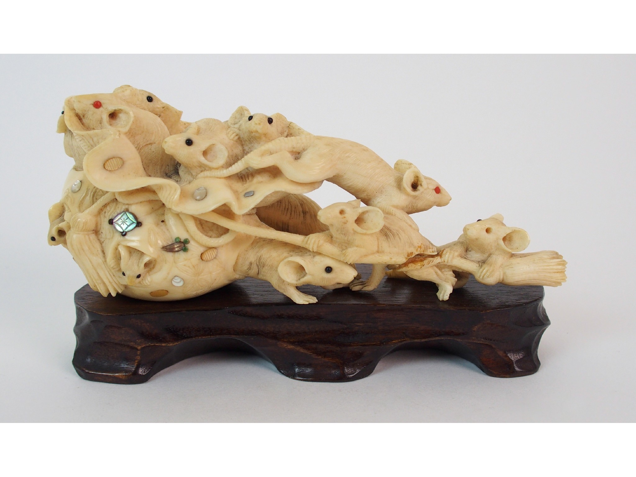 Appraisal: A Japanese ivory okimono of ratsemerging from a sack of