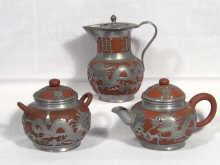 Appraisal: An Oriental terracotta and pewter three piece tea set circa