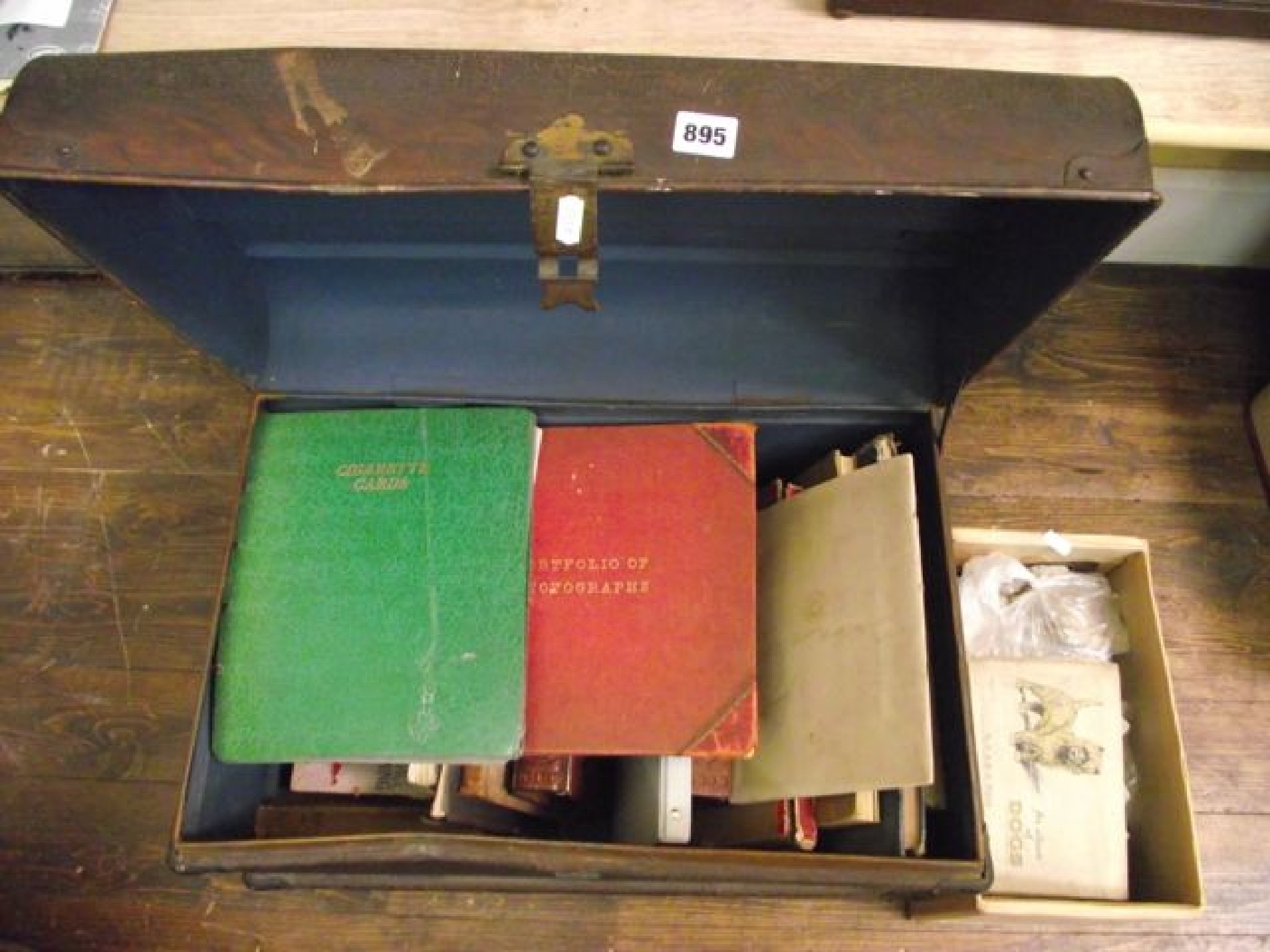 Appraisal: A tin trunk containing a quantity of miscellaneous books including