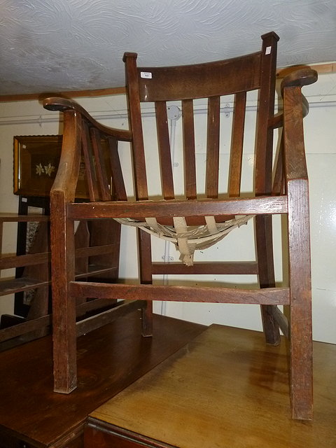 Appraisal: A LATE VICTORIAN OAK LATH BACK DESK ARMCHAIR with scrolling