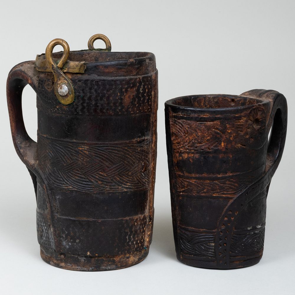 Appraisal: Two Ethnographic Carved Wood Water Vessels Comprising A brass-mounted vessel