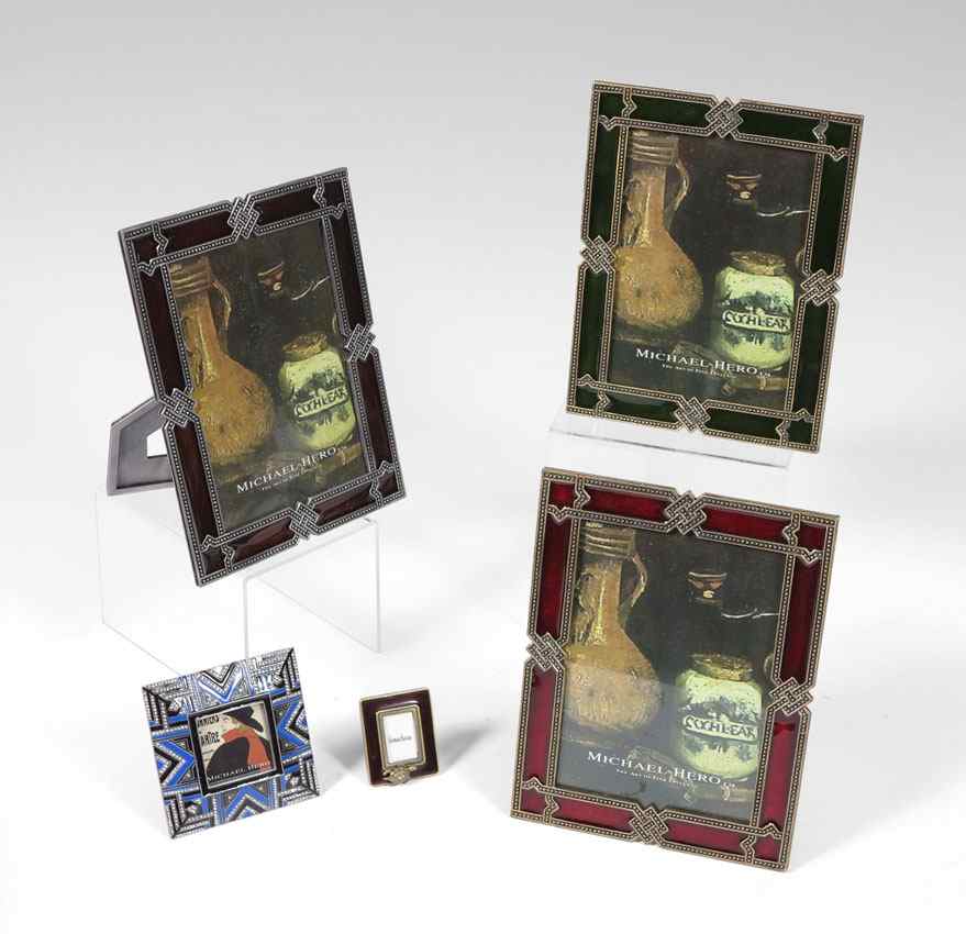 Appraisal: ENAMELED PICTURE FRAMES A miniature Jay Strongwater frog decorated enameled