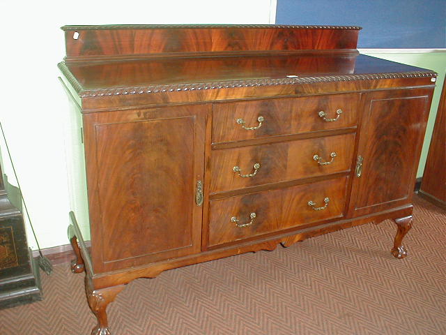 Appraisal: A 's flamed mahogany sideboard with ball and claw feet