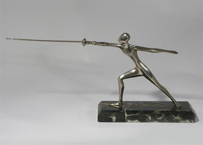 Appraisal: A silvered metal figure of a fencer on black striated