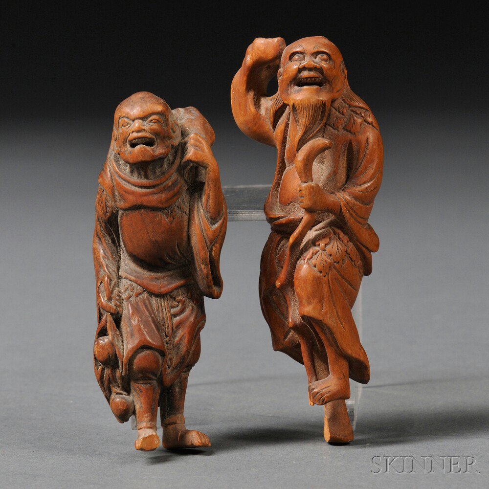 Appraisal: Two Figural Wood Netsukes Japan th century one carrying a