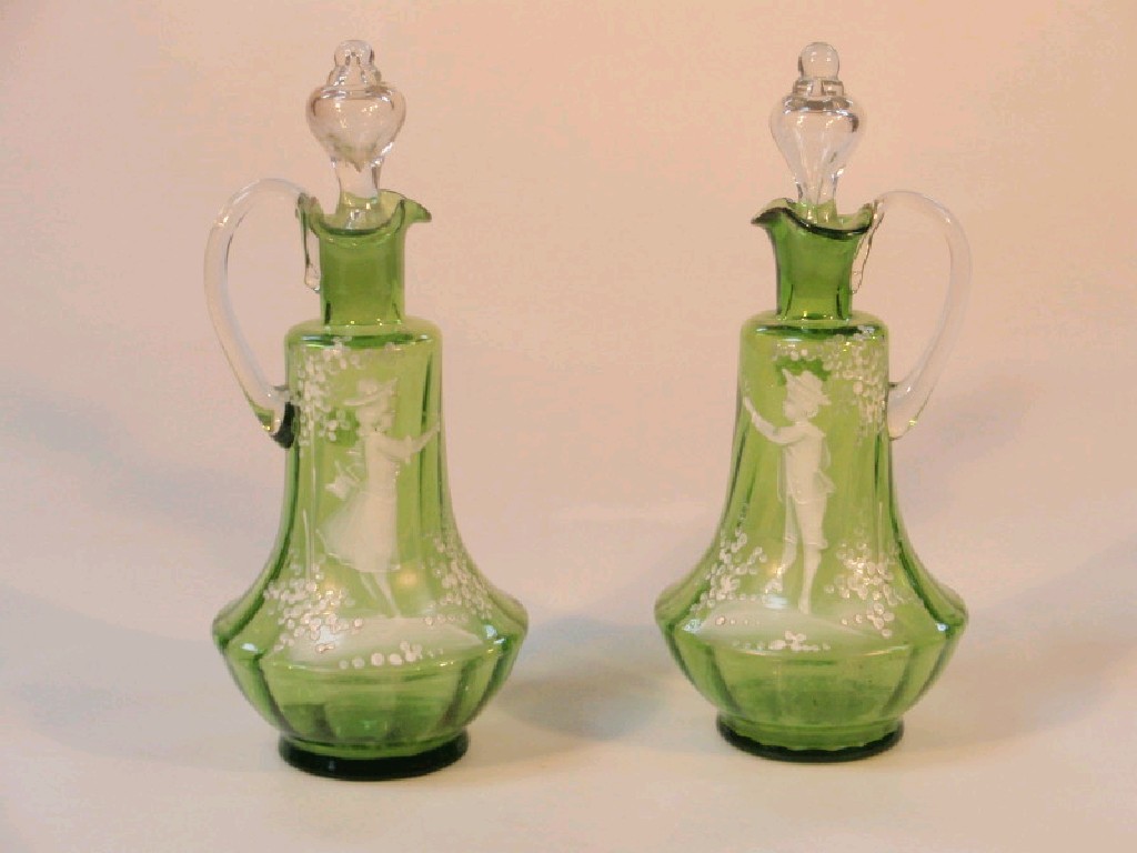 Appraisal: A pair of 'Mary Gregory' green glass ewers of moulded