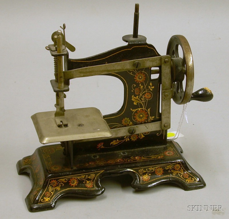 Appraisal: Transfer-Decorated Toy Sewing Machine early th century lg in wooden