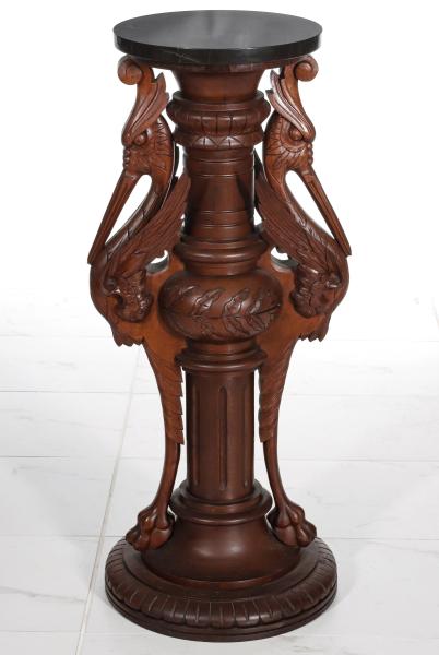 Appraisal: A GOOD CARVED WALNUT PEDESTAL WITH WINGED FIGURESThe columnar standard