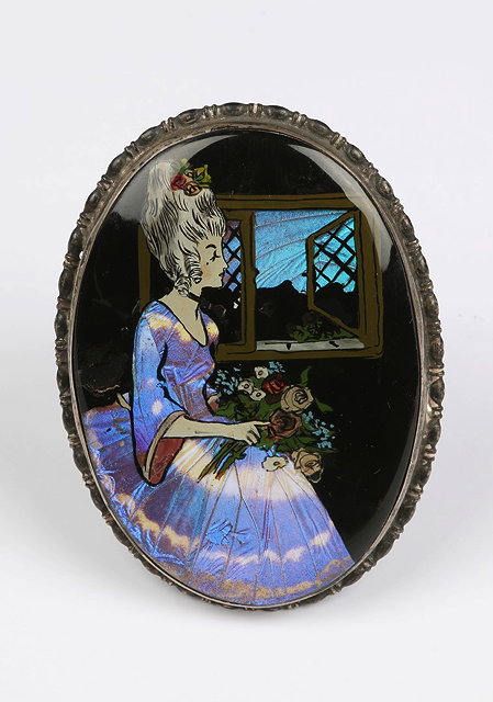 Appraisal: AN OVAL SILVER FRAME with inset miniature of a butterfly