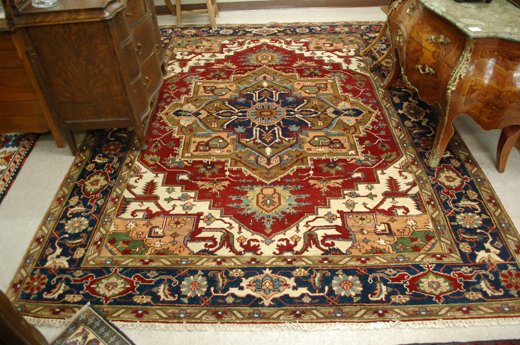 Appraisal: HAND KNOTTED ORIENTAL CARPET Persian Serapi design featuring a large