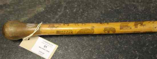 Appraisal: A Victorian penwork holly walking cane profusely decorated with animals