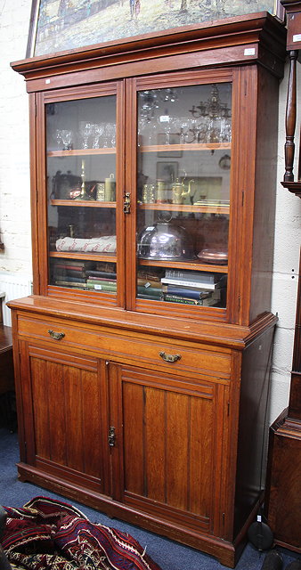 Appraisal: A LATE VICTORIAN TEAK LIBRARY BOOKCASE the glazed doors above