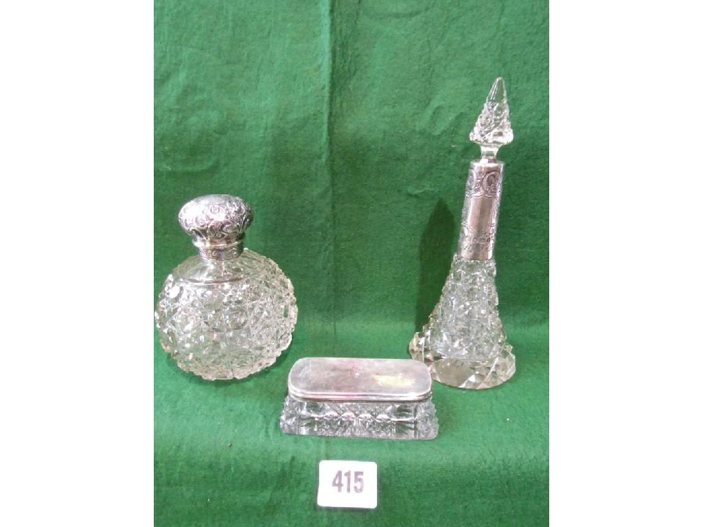 Appraisal: A cut glass spherical perfume bottle with a silver cap