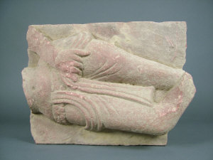 Appraisal: An Indian red sandstone panel fragment carved with the thighs