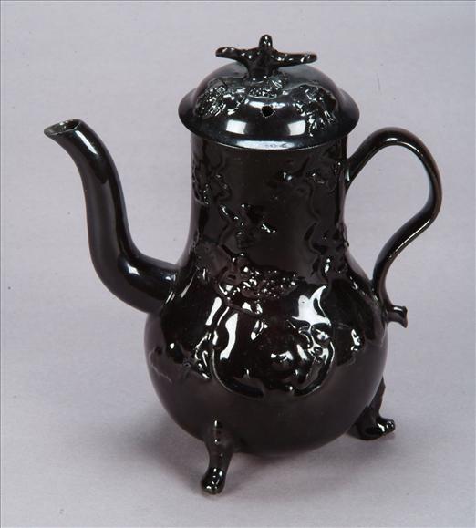 Appraisal: An English black-glazed red-pottery baluster coffee pot and cover of