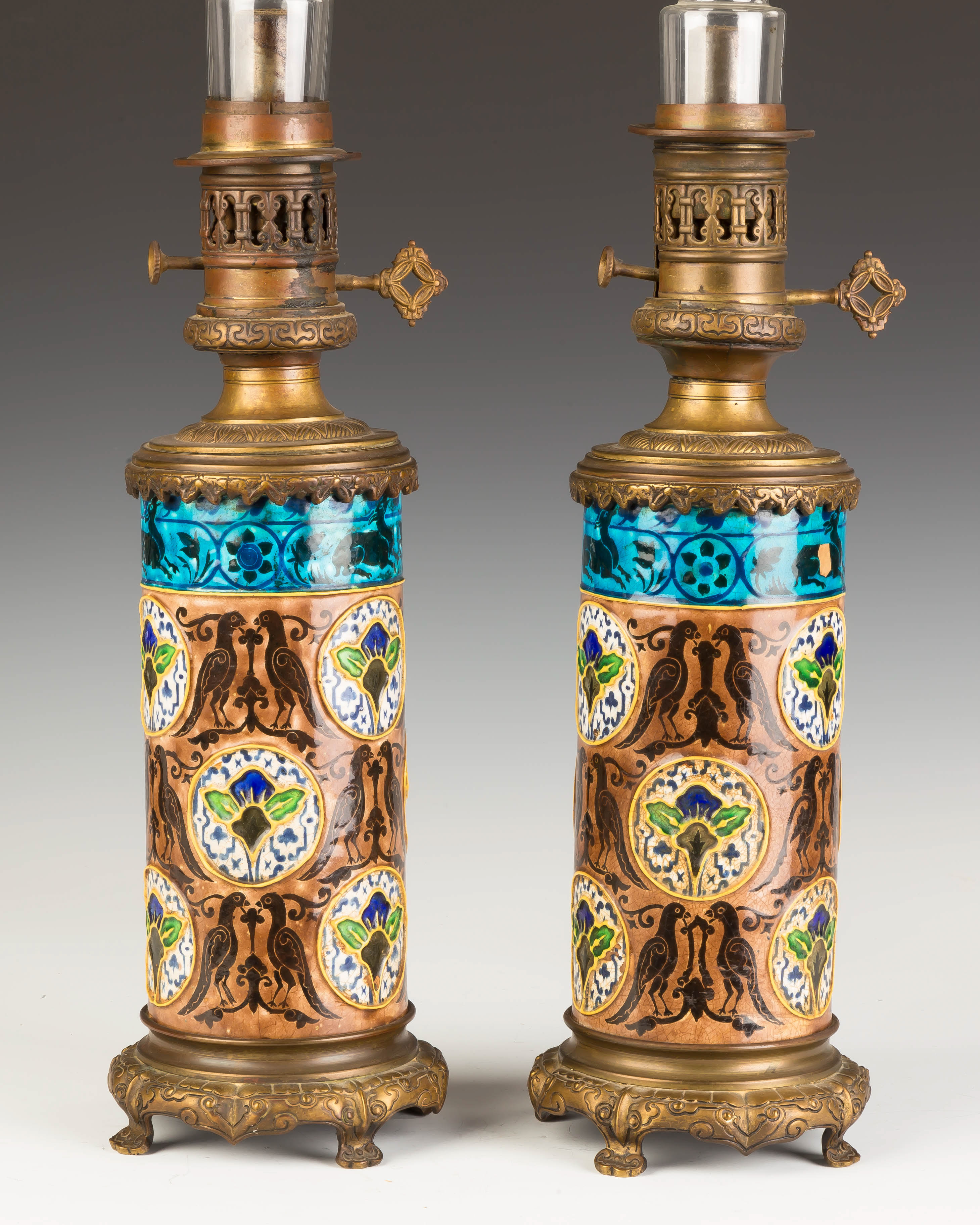 Appraisal: Pair of Victorian Aesthetic Style Oil Lamps Glazed ceramic gilt