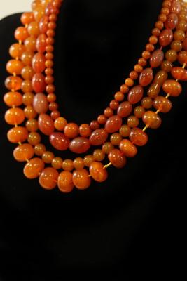 Appraisal: Three amber bead necklaces and an agate bead necklace