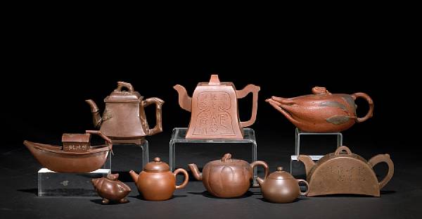 Appraisal: A group of eight Yixing teapots Including one molded as