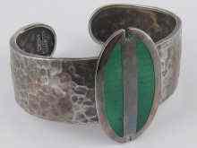 Appraisal: A silver and enamel bangle the oval enamelled plaque approx