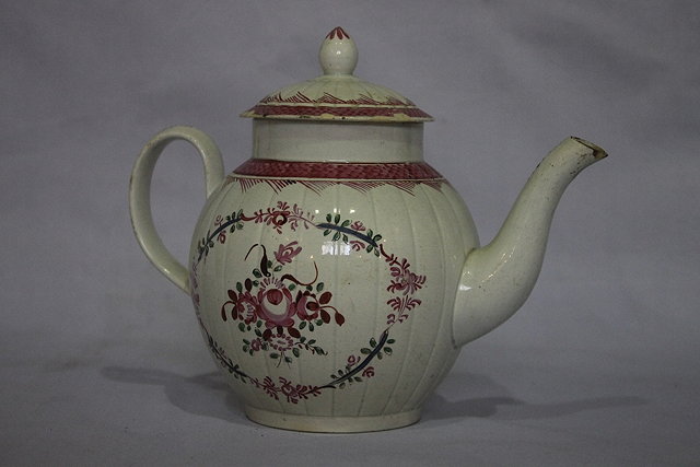 Appraisal: AN ENGLISH CREAMWARE TEAPOT and cover with painted spray and