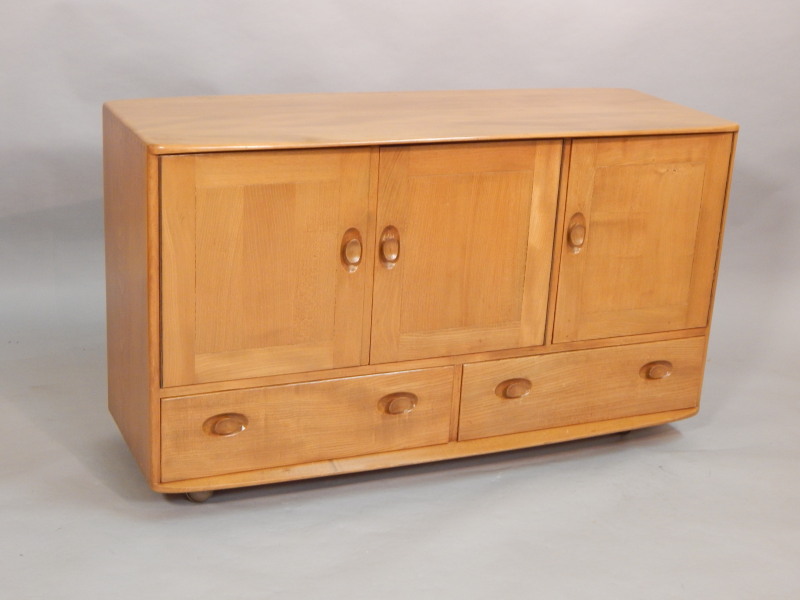 Appraisal: An Ercol light elm sideboard the rectangular shaped top above