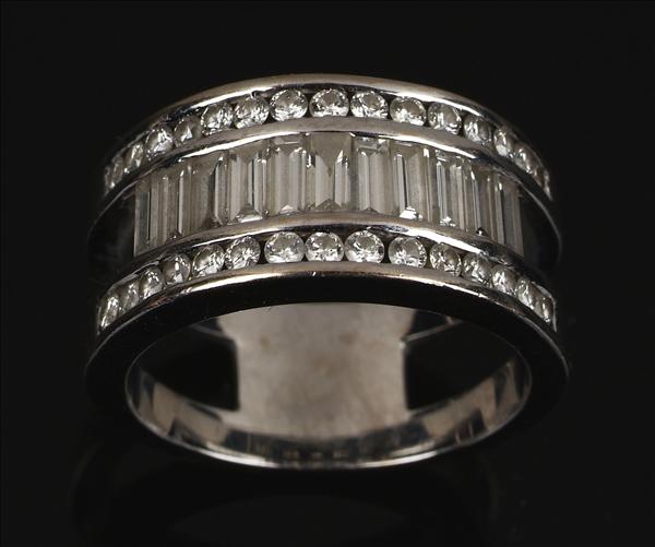 Appraisal: A diamond band ring centring on a line of baguette