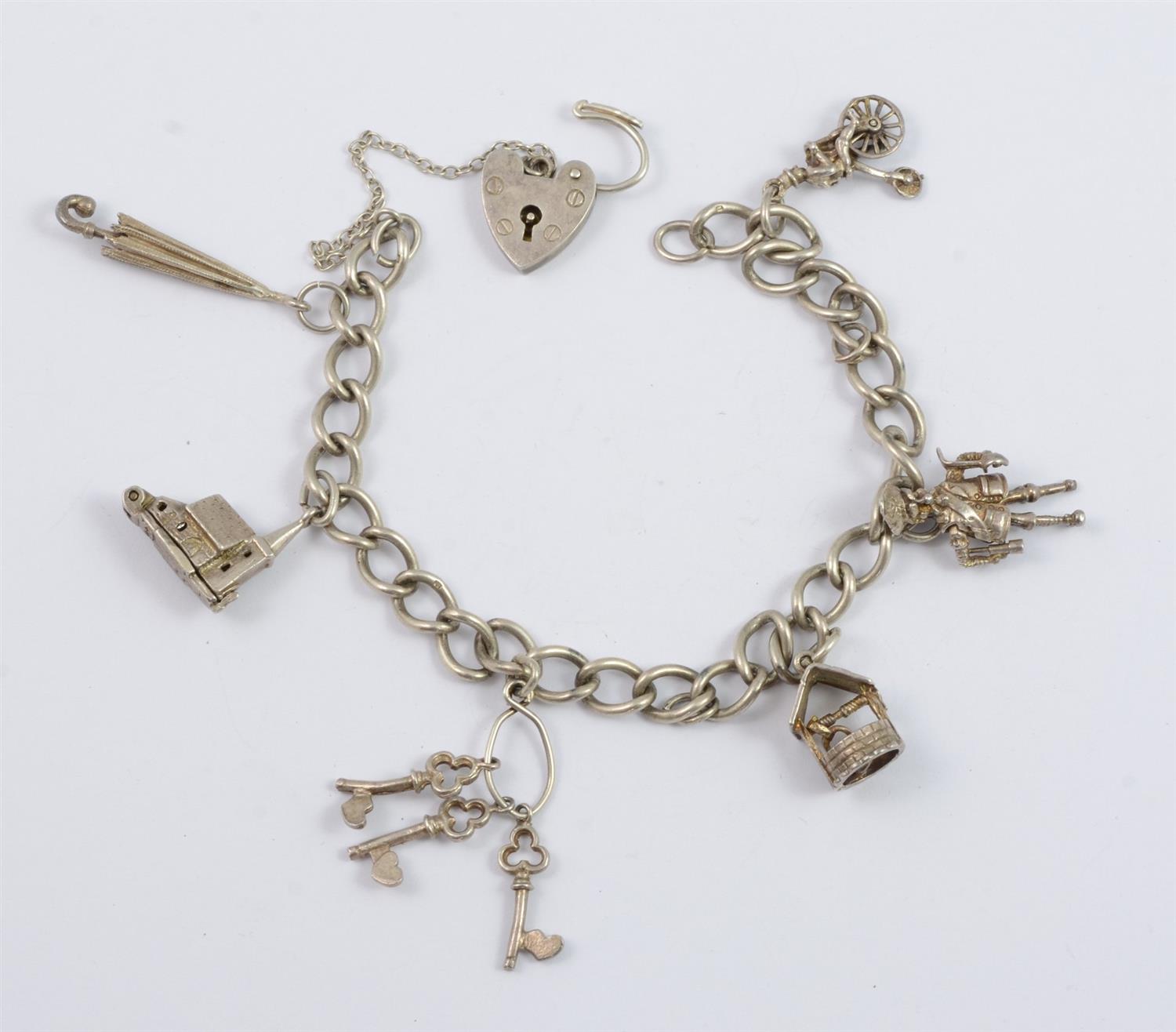 Appraisal: Sterling silver charm bracelet charms some unmarked padlock catch TO