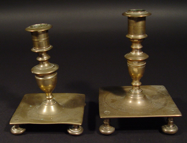 Appraisal: Two bronze th Century style square based candlesticks with turned