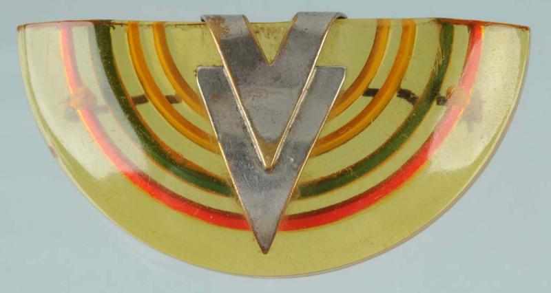 Appraisal: Bakelite Reverse Carved Pin Description With applied metal victory ornamentation