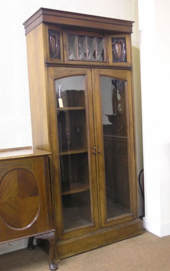 Appraisal: An unusual Art Nouveau solid walnut wardrobe angular upper section