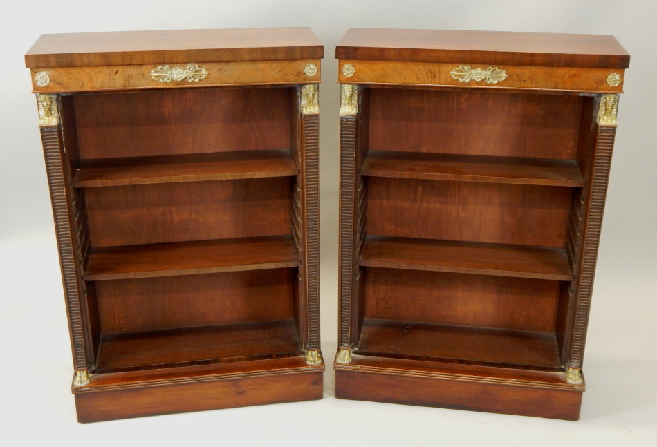 Appraisal: A pair of mahogany Regency style open bookcases with brass