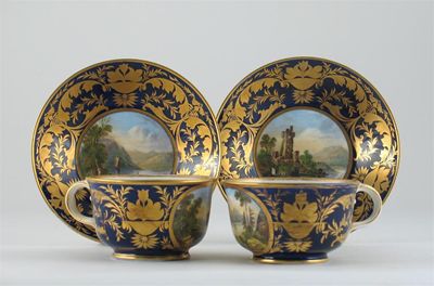 Appraisal: A pair of Derby cups and saucers painted with rural