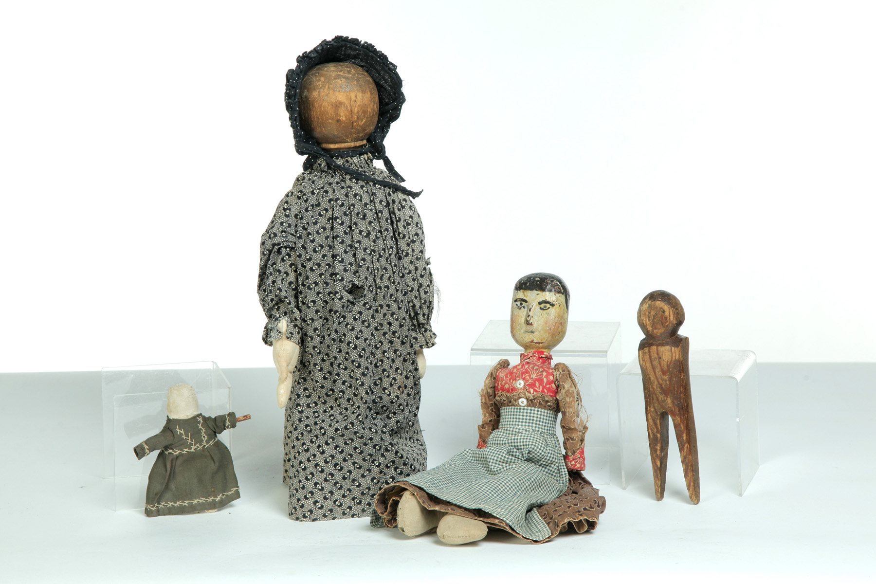 Appraisal: FOUR AMERICAN DOLLS Mid th-early th century Primitive with stick