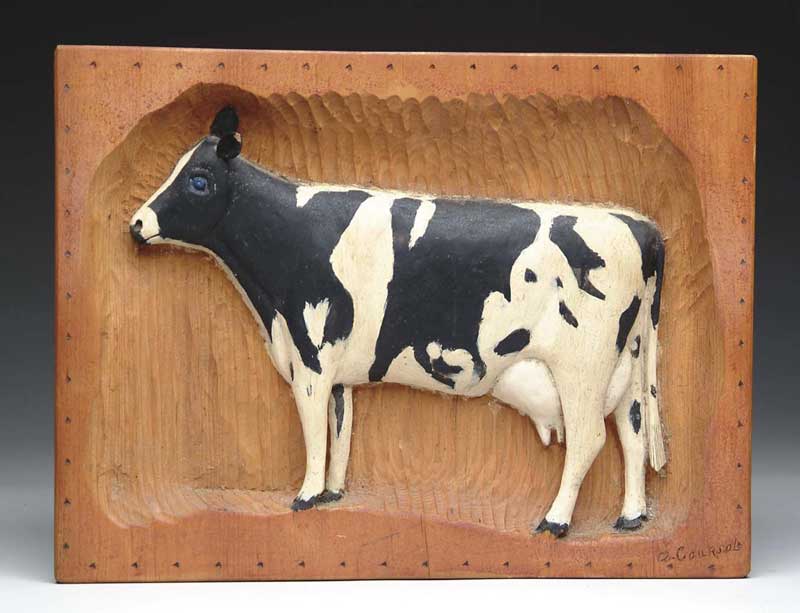 Appraisal: RELIEF CARVING OF BLACK AND WHITE COW Rectangular block of