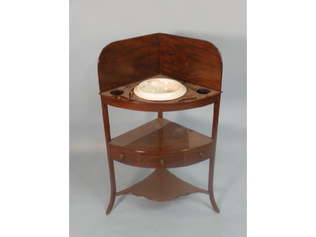 Appraisal: An early thC mahogany corner wash stand with recesses for