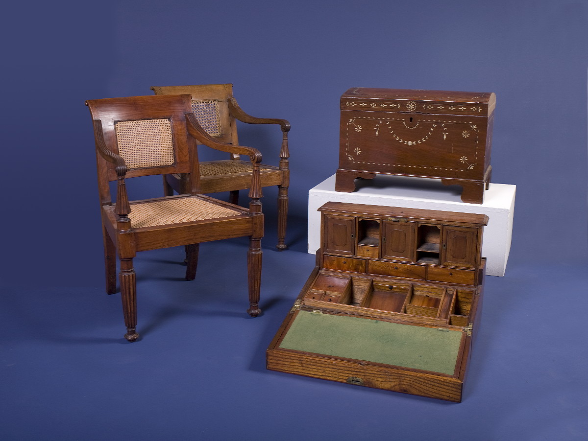 Appraisal: PAIR OF ANGLO-INDIAN CAMPHORWOOD CANED-SEAT ARMCHAIRS Each rectangular caned back