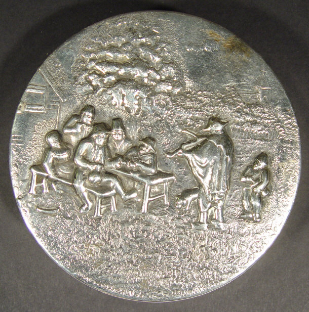 Appraisal: Circular silver plated box embossed with a scene of merriment