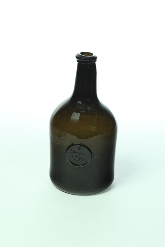 Appraisal: BLOWN GLASS BOTTLE England late th century Olive green with