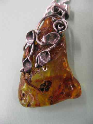 Appraisal: Amber Pendant natural form with sterling trim and '' sterling