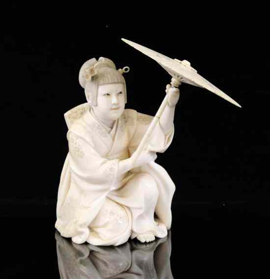 Appraisal: A Japanese ivory figure of a seated bijin early th